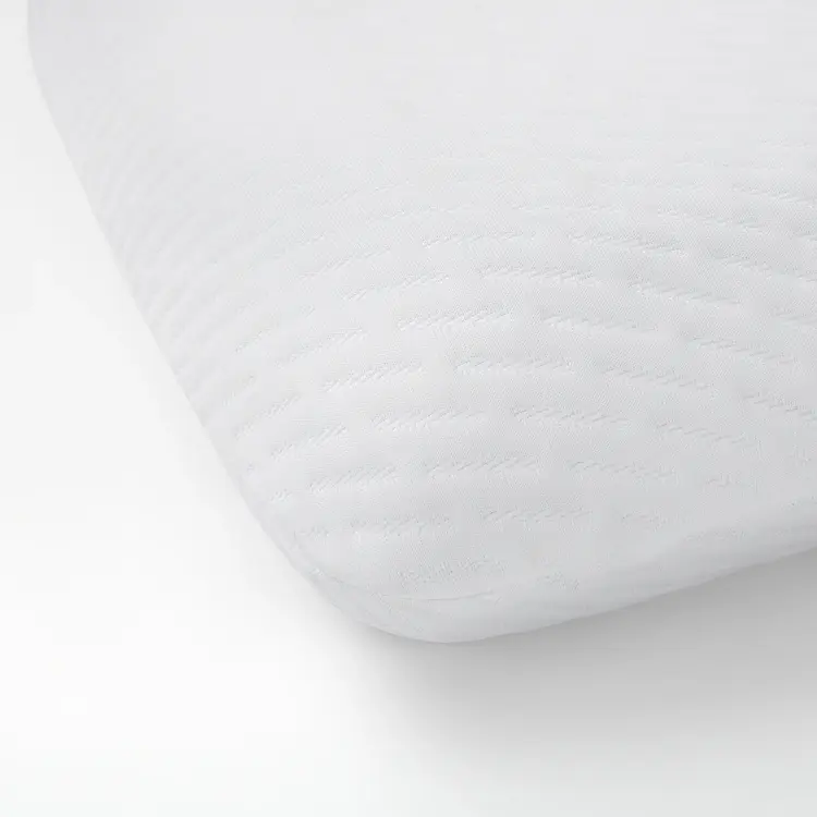 Close-up of a white Serta Nightstar pillow on a plain background